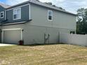 Two-story house with gray exterior and white fence at 18225 Mairdale Rd, Weeki Wachee, FL 34614