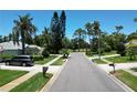 Residential street with lush landscaping and homes at 1638 Polo Club Dr, Tarpon Springs, FL 34689