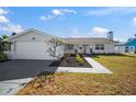 Single story home with white exterior and neutral landscaping at 910 Spindle Palm Way, Apollo Beach, FL 33572