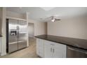Stainless steel refrigerator in kitchen with granite island at 910 Spindle Palm Way, Apollo Beach, FL 33572