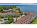 Aerial view of townhome community showcasing well-maintained landscaping, in a great location near the water at 129 Brent Cir, Oldsmar, FL 34677