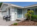 Modern front entrance with blue double doors and two wicker chairs at 1456 40Th Ne Ave, St Petersburg, FL 33703