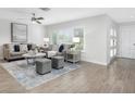 Bright living room with gray sofas, a coffee table, and a large window at 1456 40Th Ne Ave, St Petersburg, FL 33703