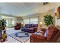 Bright living room with leather sofas and a view into another living area at 402 Blue Marlin Dr, Oldsmar, FL 34677