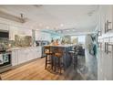 Bright and airy kitchen featuring ample cabinet space, a breakfast bar with stools, and open floor plan at 6035 Sea Ranch Dr # 505, Hudson, FL 34667