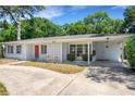 Mid-century home with mature landscaping at 303 Shore W Dr, Oldsmar, FL 34677