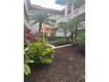 Landscaped courtyard with walking path and tropical plants at 1001 Pearce Dr # 108, Clearwater, FL 33764