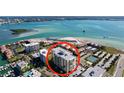 Aerial view of a waterfront building with a circular red highlight at 830 S Gulfview Blvd # 305, Clearwater Beach, FL 33767