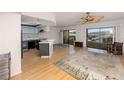 Open living and kitchen area with light wood floors at 1750 Harbor S Pl # 103, South Pasadena, FL 33707