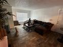Living room with sectional sofa, coffee table, and tile floors at 10200 Gandy N Blvd # 816, St Petersburg, FL 33702