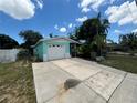 Single-story home with attached garage and a paved driveway at 5060 86Th Ave N, Pinellas Park, FL 33782
