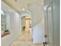 Inviting foyer with archways, light tile floors, and a view to the bright and airy living spaces at 19830 Ellendale Dr, Land O Lakes, FL 34638