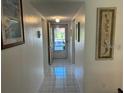 Bright hallway with tiled floors and framed art at 2060 Marilyn St # 124, Clearwater, FL 33765