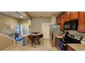 The kitchen features stainless steel appliances, wood cabinets, and a cozy breakfast nook with seating for four at 10254 Red Currant Ct, Riverview, FL 33578