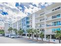 Building exterior with parking and landscaping at 19610 Gulf Blvd # 409, Indian Shores, FL 33785