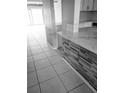 Partial view of a kitchen with white cabinets and quartz countertops at 318 Windrush Blvd # 9, Indian Rocks Beach, FL 33785