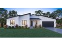 Modern one-story home with a black garage door at 6700 Burlington N Ave, St Petersburg, FL 33710