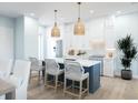 Modern kitchen with white cabinets and a blue island at 6700 Burlington N Ave, St Petersburg, FL 33710