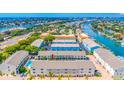 Enjoy breathtaking water views in this aerial view of a waterfront condo, with boat docks and tropical landscaping at 1109 Pinellas Bayway S # 306, Tierra Verde, FL 33715