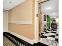 Hallway with beige walls and a view into a colorful hallway at 36750 Us Highway 19 N # 03102, Palm Harbor, FL 34684