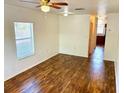 Simple living room with wood-look floors and ceiling fan at 5816 Congress St # 104, New Port Richey, FL 34653