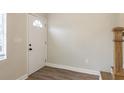Bright entryway with a white front door, wood-look flooring, and neutral paint at 49 W Boyer St, Tarpon Springs, FL 34689