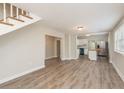 Open living area featuring a staircase, wood-look floors, and seamless transition to kitchen at 49 W Boyer St, Tarpon Springs, FL 34689