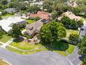 Beautiful aerial view of the single-story home, lush landscaping and mature trees on a meticulously maintained lot at 1570 Preserve Way, Clearwater, FL 33764