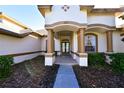 Inviting home entrance featuring stone accents, manicured landscaping, and a covered porch at 1570 Preserve Way, Clearwater, FL 33764