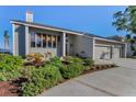 Well-maintained home with a spacious driveway and mature green landscaping at 526 Belle Isle Ave, Belleair Beach, FL 33786