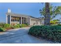 Attractive home featuring a spacious driveway and lush, verdant landscaping at 526 Belle Isle Ave, Belleair Beach, FL 33786
