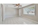 Light-filled living room with tile floors and a window at 3353 Columbus Dr, Holiday, FL 34691