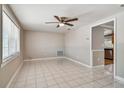 Bright living room with tile floors and ceiling fan at 3353 Columbus Dr, Holiday, FL 34691