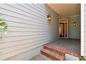 Brick steps leading to a covered entryway with red door at 2848 Bayshore Trails Dr, Tampa, FL 33611