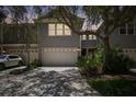 Two-story house with a gray exterior, two-car garage, and landscaped yard at 2848 Bayshore Trails Dr, Tampa, FL 33611