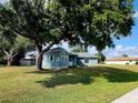 View of the home's exterior and a detached shed at 7267 Teaberry St, Englewood, FL 34224