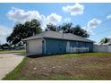 Single car garage with white door and a small fenced yard at 7267 Teaberry St, Englewood, FL 34224