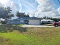 House exterior view, showing front yard and driveway at 7267 Teaberry St, Englewood, FL 34224