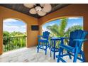 Relaxing balcony featuring comfortable seating and a beautiful view of tropical foliage and blue skies at 620 Ponce De Leon Dr, Tierra Verde, FL 33715