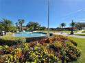 Circular fountain with colorful flowers in the Crescent Oaks community at 3181 Sterling St, Tarpon Springs, FL 34688