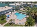 Enjoy the beautiful private outdoor swimming pool with sundeck, chairs, and landscaping at 6201 2Nd E St # 73, St Pete Beach, FL 33706