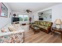 Bright living room with wicker furniture and wood-look floors at 12760 Indian Rocks Rd # 1036, Largo, FL 33774