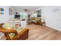 Bright living room with wicker furniture and wood-look floors at 12760 Indian Rocks Rd # 1036, Largo, FL 33774