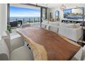 Bright living room featuring wood table, sleek furniture and ocean views from the large sliding glass doors to the patio at 100 1St N Ave # 2205, St Petersburg, FL 33701