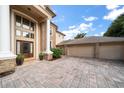 Grand home entrance with columns and three-car garage at 667 Richmond Close, Tarpon Springs, FL 34688