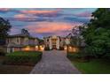 Elegant home at dusk with a beautiful sunset in the background at 667 Richmond Close, Tarpon Springs, FL 34688