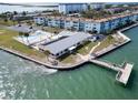 Aerial view of a waterfront community with a clubhouse, pool, and dock at 9 Haig Pl # 806, Dunedin, FL 34698