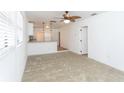 Bright living room with neutral carpet, ceiling fan, and open concept design at 1616 18Th Street E Ct, Palmetto, FL 34221