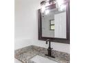 Updated bathroom features granite vanity, modern fixtures, and a frameless shower at 1616 18Th Street E Ct, Palmetto, FL 34221