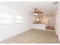 Spacious living room with neutral carpet and ceiling fan at 1616 18Th Street E Ct, Palmetto, FL 34221
